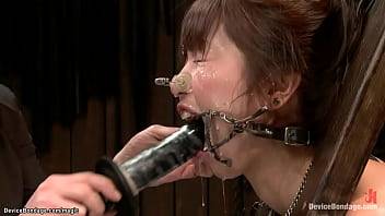 Gagged Japanese slut Marica Hase throat fucked through spider gag with dildo then ass whipped and finger fucked by lezdom Claire Adams on device bondage