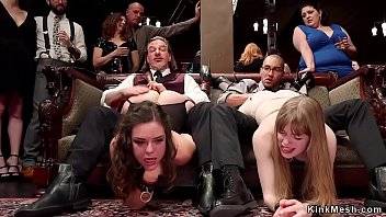 Two slaves sharing big black cock at bdsm orgy party