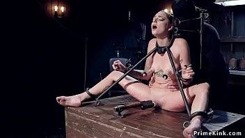 Tattooed blonde slave is vibed on the floor in bondage then locked in metal device
