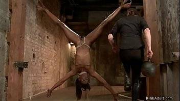 Laid over wooden beam with face down to the floor and arms in strappado ebony slave Ana Foxxx gets ass hooked and spanked by lezdom Claire Adams