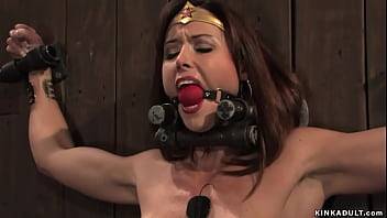 Busty Wunder Woman bound to the wall